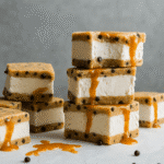 Caramel chocolate chip cookie ice cream sandwiches stacked on a plate